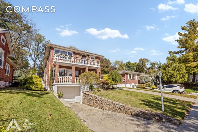 view of front of property featuring a balcony, covered porch, and a front yard