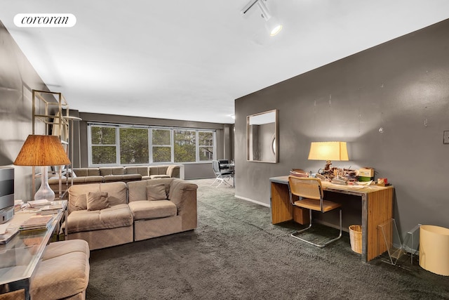 living room featuring carpet flooring, visible vents, baseboards, and track lighting