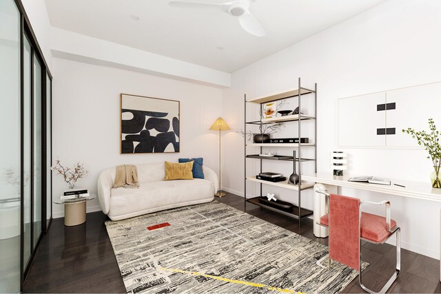 sitting room with wood finished floors, a ceiling fan, and baseboards