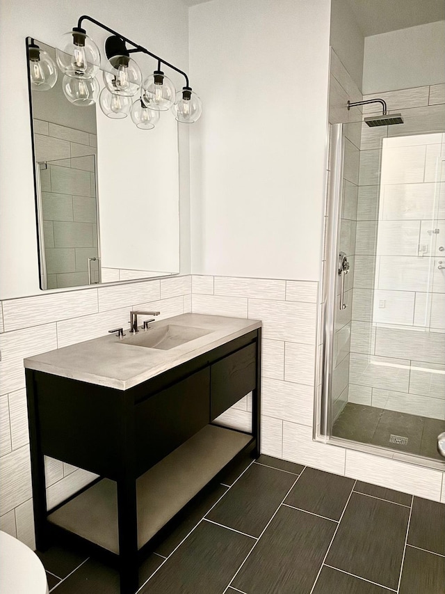 full bath with a shower stall, tile walls, toilet, and vanity