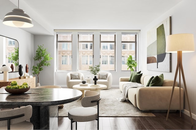 living area with baseboards and wood finished floors