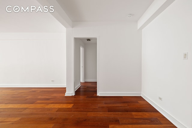 empty room featuring baseboards and wood finished floors