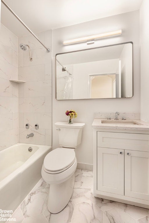 full bathroom featuring toilet, tiled shower / bath, and vanity