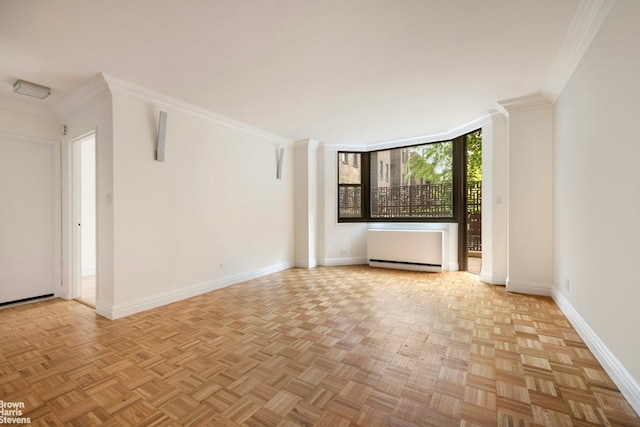 empty room with light parquet floors and crown molding