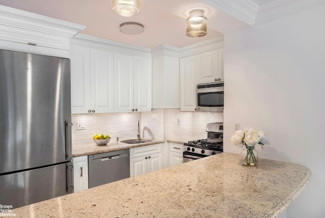 kitchen with light stone counters, white cabinets, and appliances with stainless steel finishes