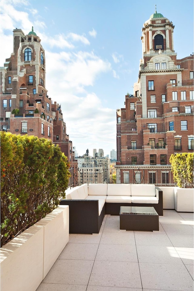 view of community featuring a view of city, a patio area, and outdoor lounge area