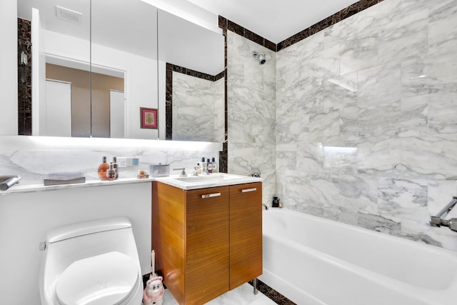 full bathroom featuring tiled shower / bath, vanity, and toilet