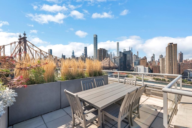 view of patio / terrace with a view of city and outdoor dining space