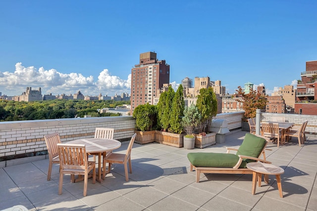 view of patio with a view of skyline and outdoor dining space