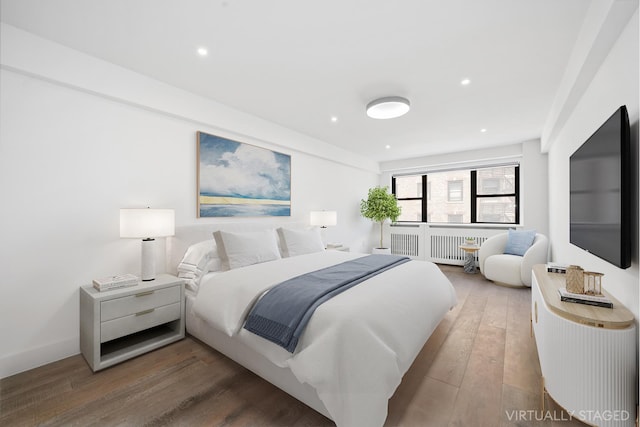 bedroom with recessed lighting, wood-type flooring, and baseboards