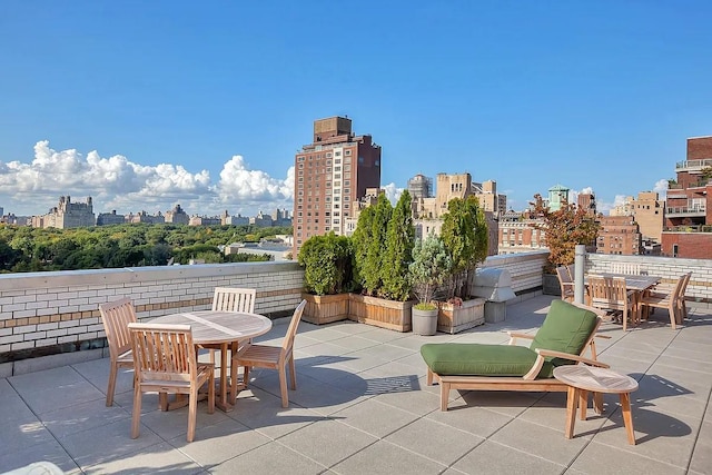 view of patio / terrace with a skyline view and outdoor dining space