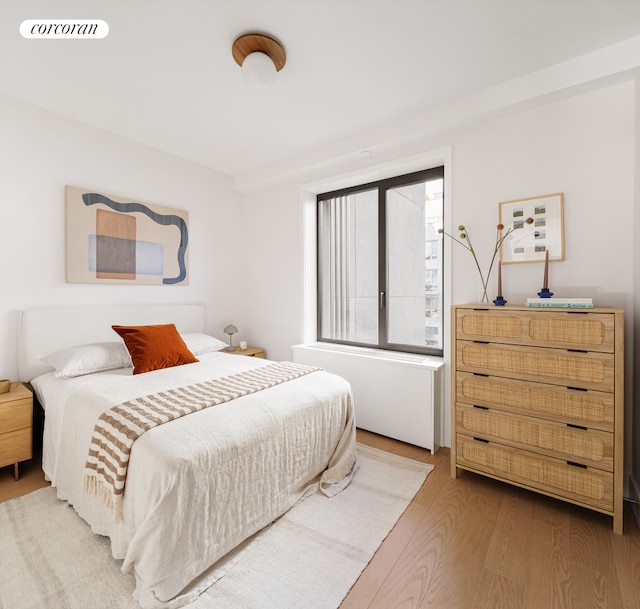 bedroom featuring visible vents and wood finished floors