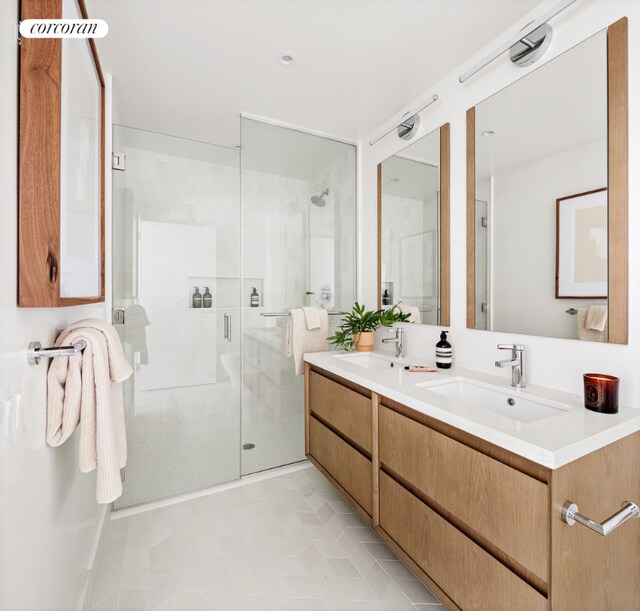 bathroom with walk in shower, vanity, and tile patterned flooring