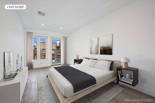 bedroom featuring access to exterior and dark wood-type flooring