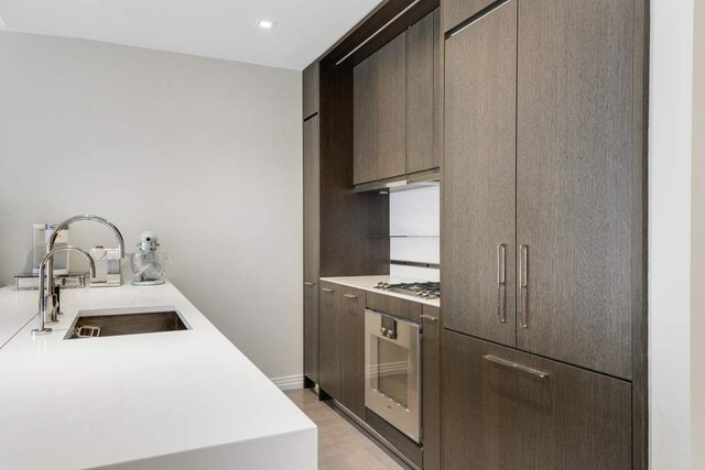 laundry area featuring light wood-type flooring and stacked washing maching and dryer