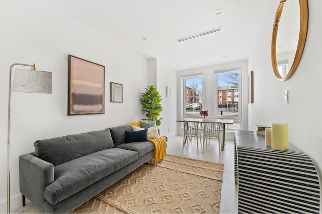 living area featuring visible vents and recessed lighting
