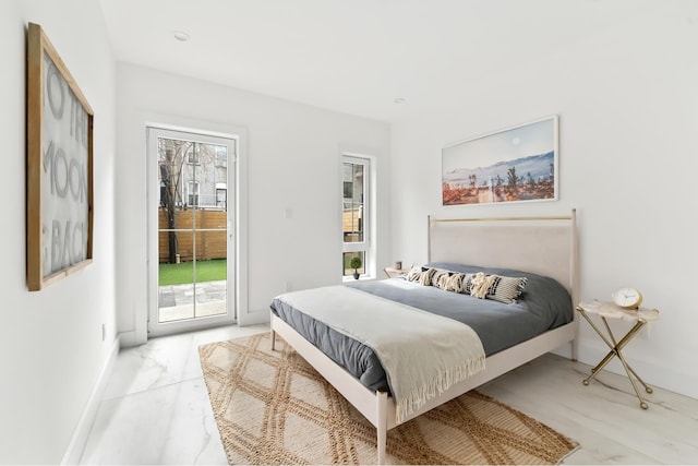 bedroom with access to exterior, marble finish floor, baseboards, and multiple windows