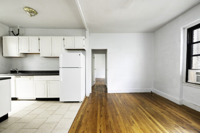 kitchen featuring white cabinetry, sink, white appliances, and light hardwood / wood-style flooring