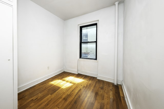 unfurnished room featuring dark hardwood / wood-style flooring