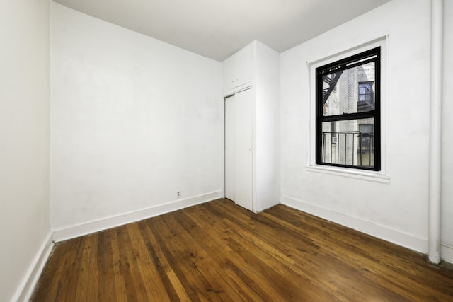 empty room featuring dark wood-type flooring