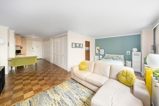 living room with ornamental molding and dark parquet floors