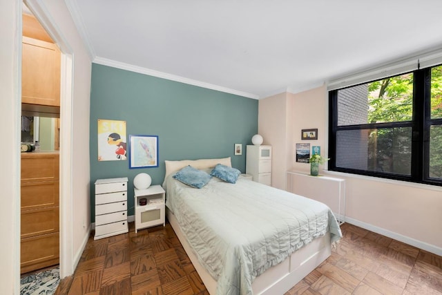 bedroom with parquet flooring and crown molding