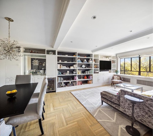 living room featuring wine cooler, light parquet floors, ornamental molding, a notable chandelier, and beam ceiling