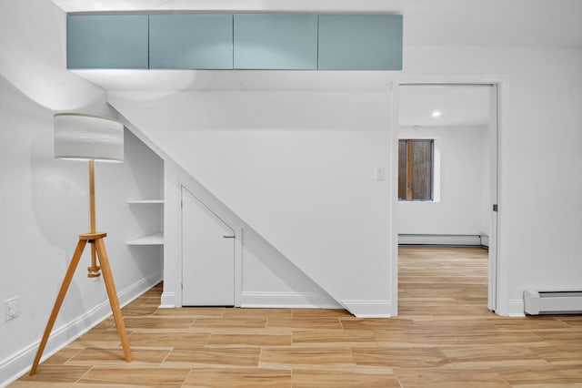 interior space with baseboards, a baseboard radiator, baseboard heating, and wood tiled floor