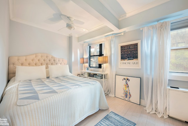 bedroom with ceiling fan, light wood finished floors, multiple windows, and crown molding