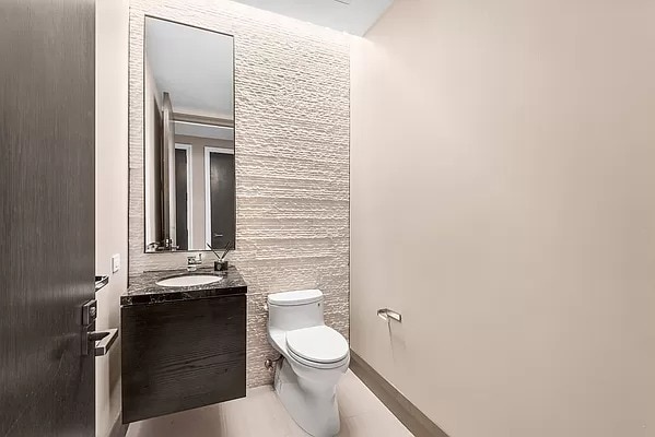 172 Madison Ave Unit 4B, New York City, NY 10016 - bathroom with toilet, vanity, and tile patterned floors