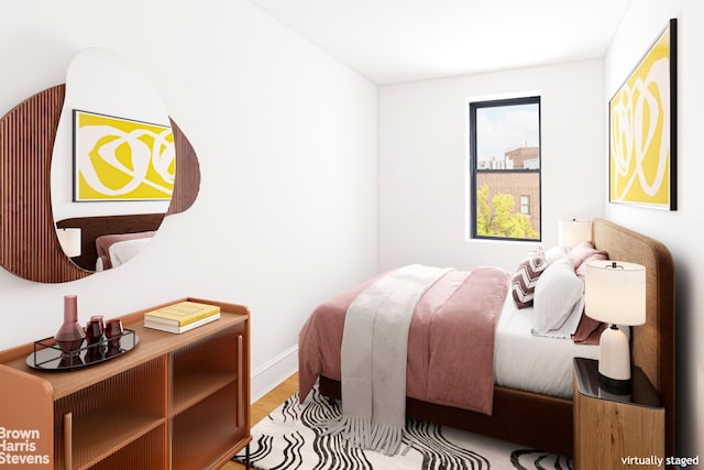 bedroom featuring light wood-type flooring and baseboards