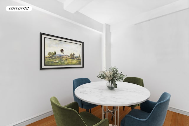 dining space with light wood-style floors and baseboards