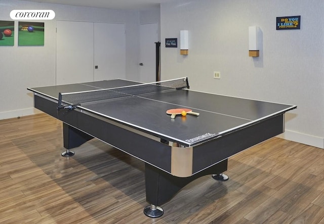 recreation room with baseboards and wood finished floors