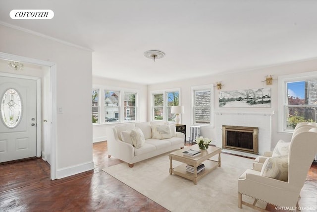 living room featuring crown molding, hardwood / wood-style floors, and plenty of natural light