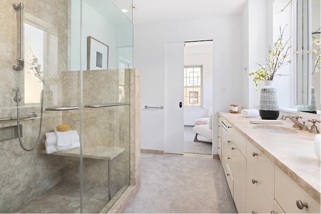 bathroom with a stall shower and vanity