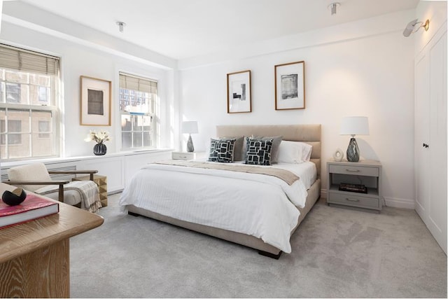 bedroom featuring light colored carpet