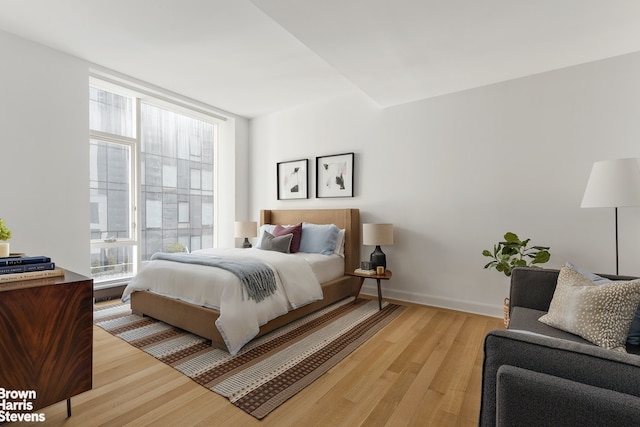 bedroom featuring light wood-style floors and baseboards