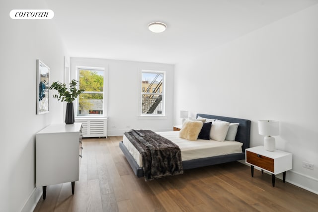 bedroom with dark hardwood / wood-style floors