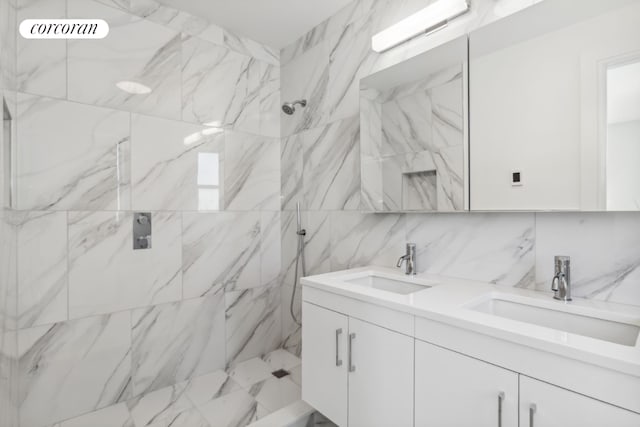 bathroom featuring vanity, tiled shower, and backsplash