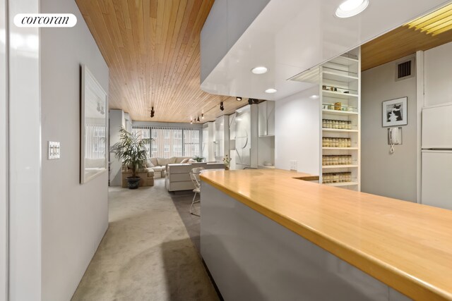 dining area with sink, wooden ceiling, and rail lighting