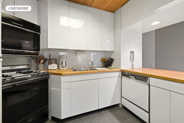 kitchen with range with gas stovetop, dishwasher, sink, butcher block counters, and white cabinets