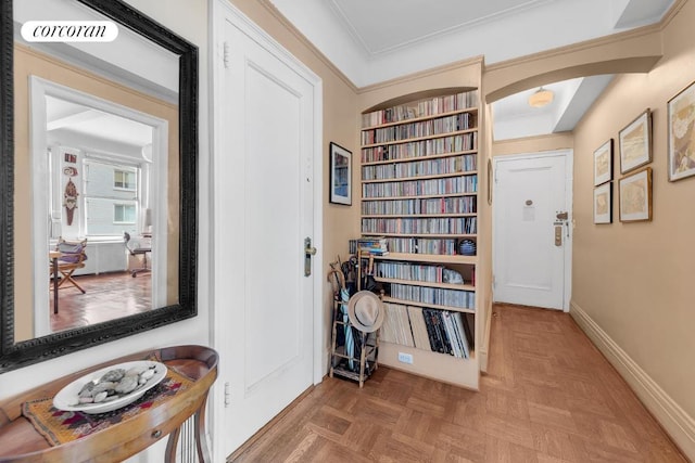 corridor with parquet floors and crown molding