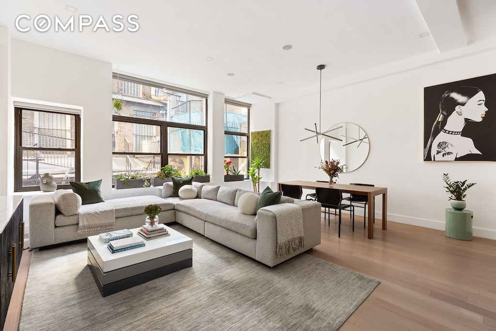 living area featuring light wood-style flooring and baseboards