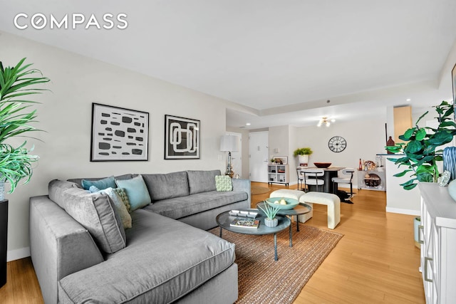 living area with light wood-style floors and baseboards