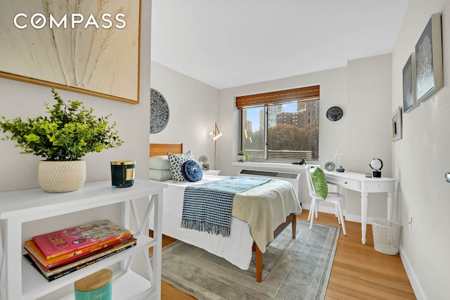 bedroom with baseboards and wood finished floors