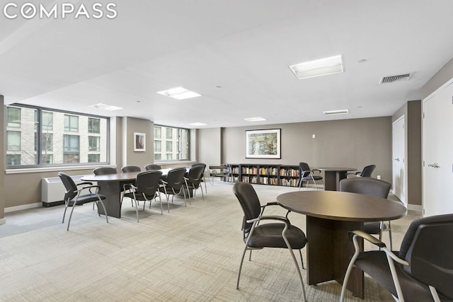 dining area featuring light carpet