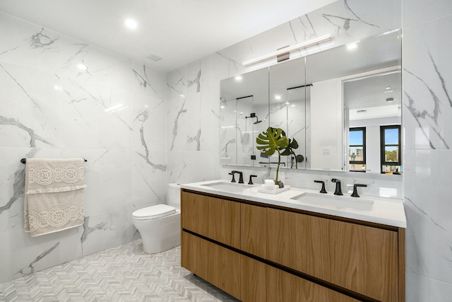 bathroom featuring vanity, a shower, tile walls, and toilet