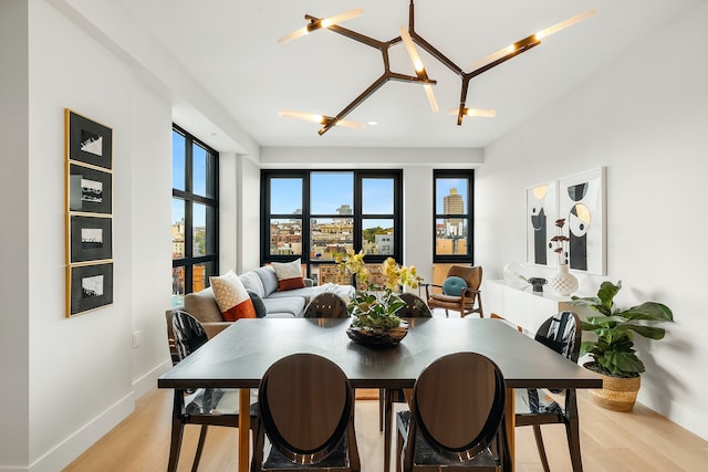 dining room featuring light wood-type flooring and baseboards