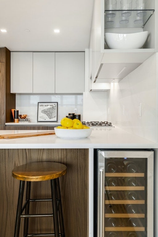 bar featuring white gas stovetop, wine cooler, a dry bar, and recessed lighting