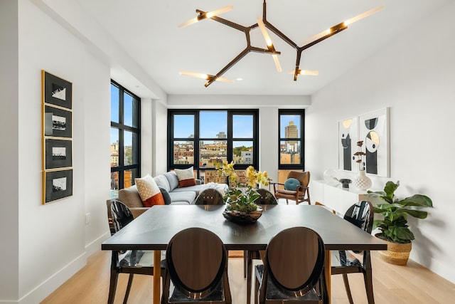 dining area featuring a chandelier and light hardwood / wood-style floors